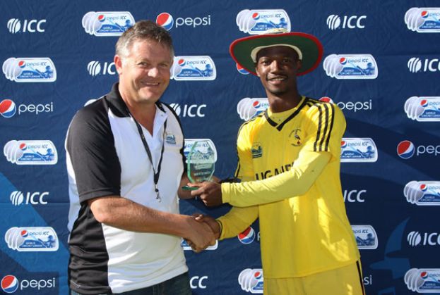 Davis Karashani (right) receiving an a Man Of The Match award for Team Uganda at a previous Internationa Cricket Council tournament. He is now retired. photo by ICC 