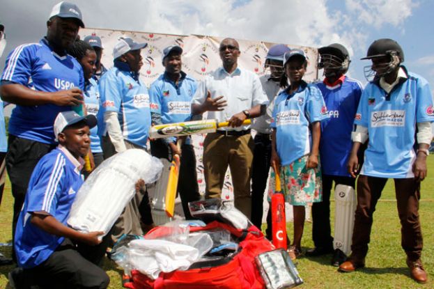 Cricket CEO Ligyalingi (R) handing over equipment and jerseys to Uspa president Sabiiti Muwanga at Lugogo on Monday after the Assembly. Photo By ISMAIL KEZAALA 