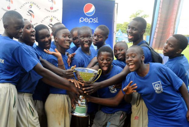 Jinja SS girls getting a feel of the trophy after emerging best in the Pepsi Girls Twenty20 Schools Cricket week. PHOTO BY EDDIE CHICCO