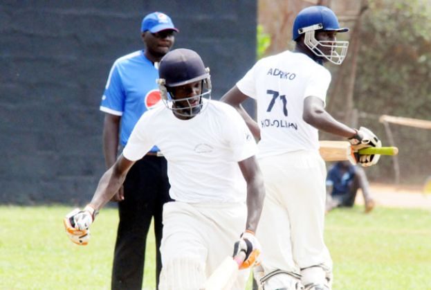 Kololo SS’ batsmen Adriko (R) and Siraje Nsubuga complete a single as umpire Norbert Abii looks on. The pair have been key in Kololo’s unbeaten run thus far. PHOTO BY EDDIE CHICCO  